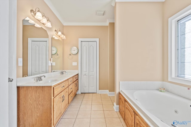 full bathroom with a jetted tub, a wealth of natural light, a sink, and tile patterned floors