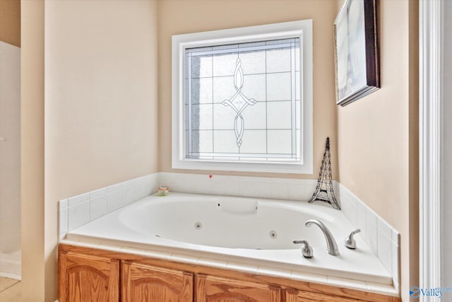 full bath featuring a tub with jets and a wealth of natural light