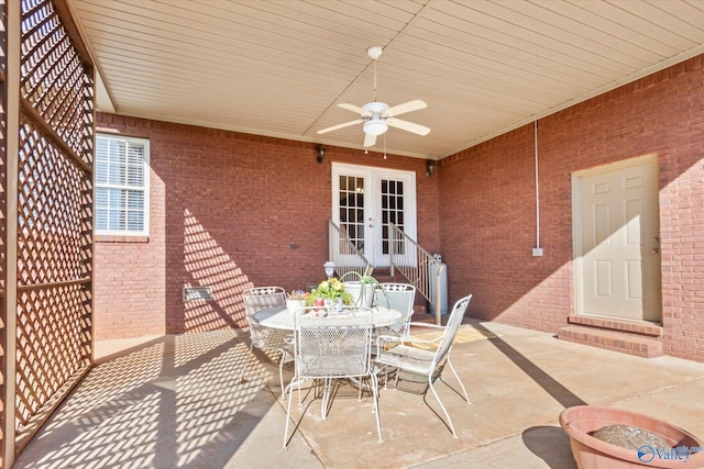 view of patio featuring a ceiling fan, entry steps, french doors, and outdoor dining area