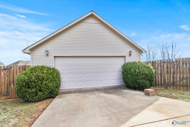 detached garage featuring fence