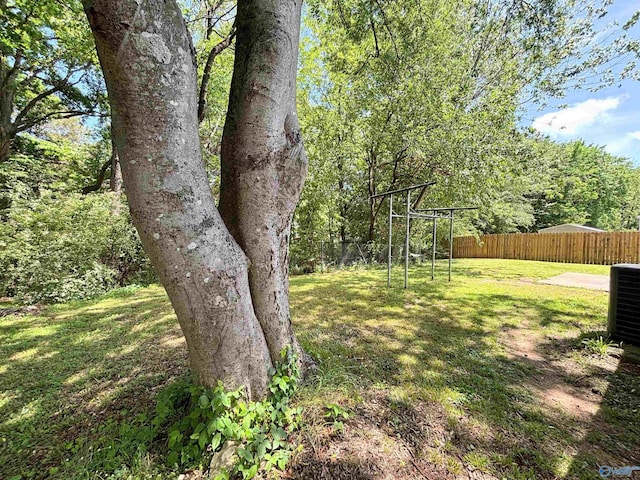 view of yard with cooling unit and fence