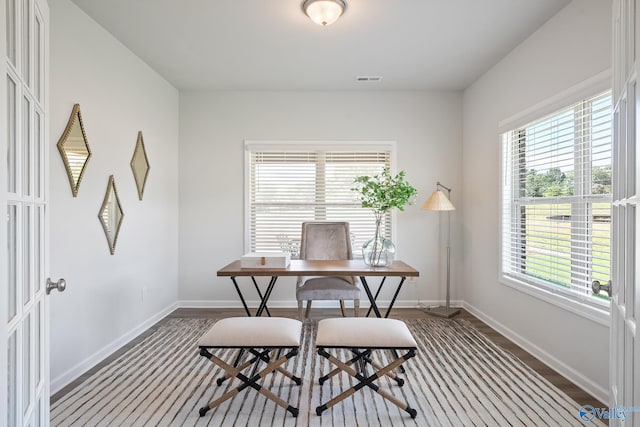 office area with baseboards, visible vents, and plenty of natural light