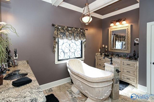 full bath with stone finish flooring, baseboards, ornamental molding, vanity, and a freestanding bath
