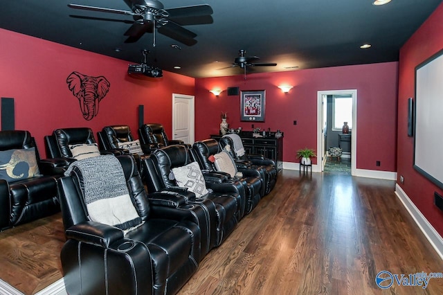 home theater room featuring a ceiling fan, baseboards, and wood finished floors