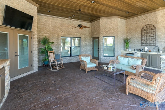 view of patio with outdoor lounge area, exterior kitchen, and ceiling fan