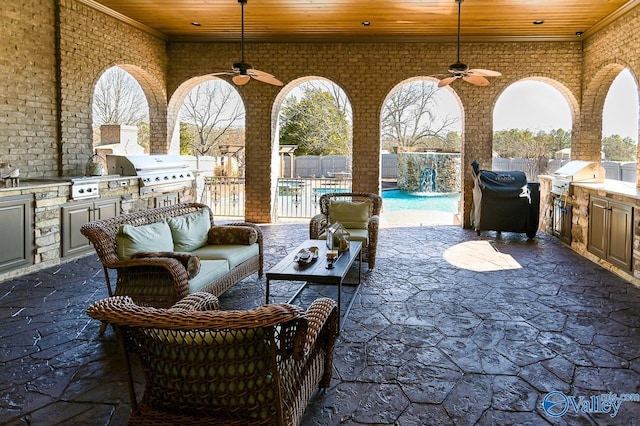 view of patio with outdoor lounge area, exterior kitchen, a fenced backyard, and grilling area