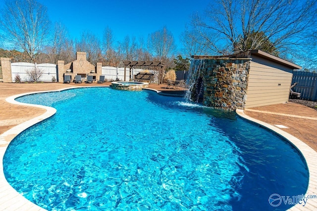 view of pool with a fenced backyard, a pool with connected hot tub, a patio area, and a pergola