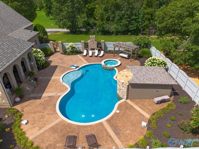 view of swimming pool with a fenced backyard, a pool with connected hot tub, and a patio area