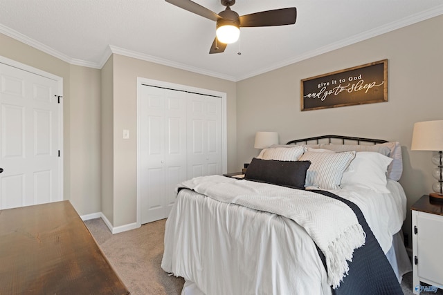 bedroom featuring baseboards, ornamental molding, light carpet, a closet, and a ceiling fan