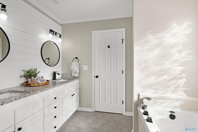 full bathroom with a sink, double vanity, a jetted tub, and ornamental molding