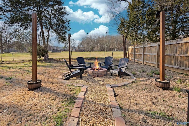 view of yard featuring a fire pit and fence