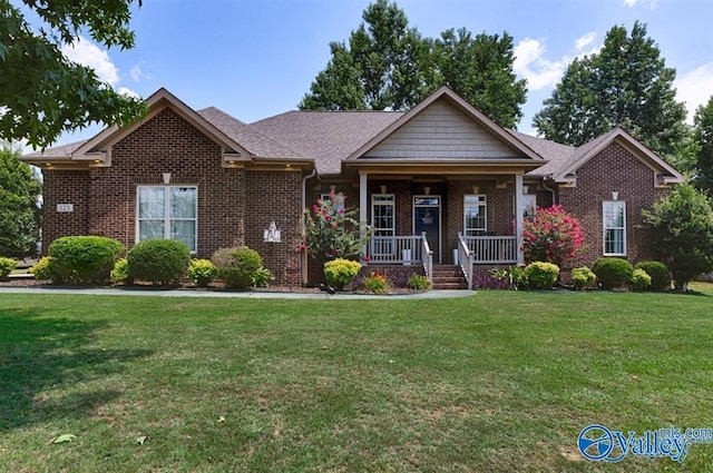 view of front of home with a front yard and covered porch