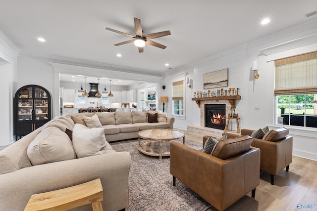 313 Merrydale Dr, Huntsville, AL 35811 - living room featuring a ceiling fan, light wood finished floors, a glass covered fireplace, and recessed lighting