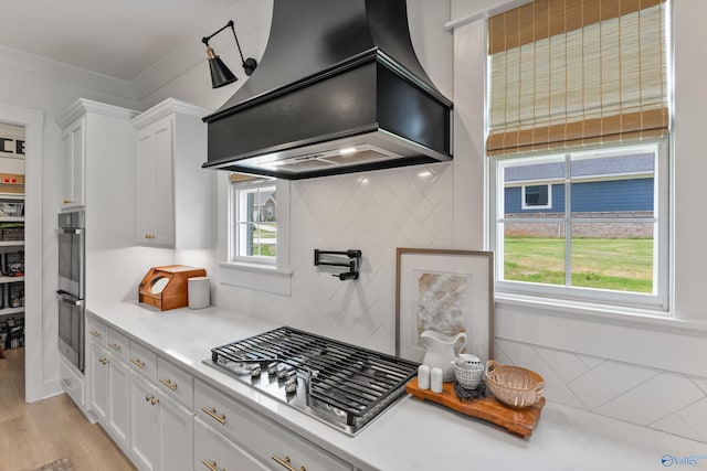 313 Merrydale Dr, Huntsville, AL 35811 - kitchen featuring appliances with stainless steel finishes, custom exhaust hood, white cabinetry, and light countertops