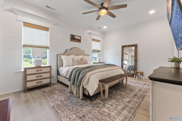 313 Merrydale Dr, Huntsville, AL 35811 - bedroom featuring multiple windows, light wood-style floors, wood walls, ceiling fan, and recessed lighting