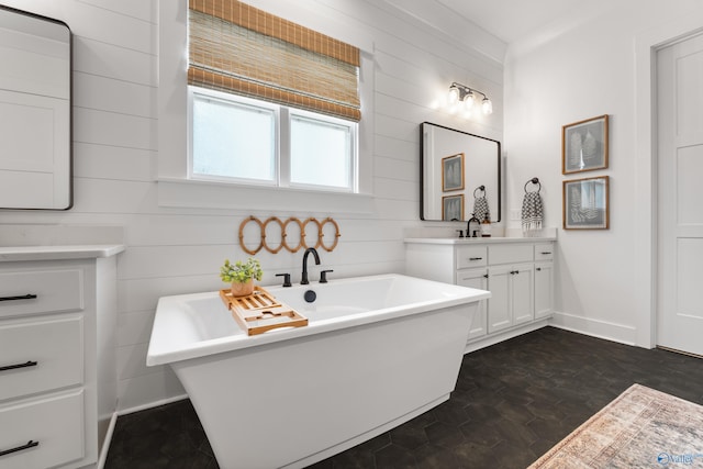 313 Merrydale Dr, Huntsville, AL 35811 - bathroom featuring vanity, a freestanding tub, and wood walls