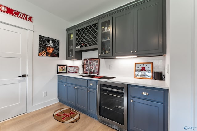 313 Merrydale Dr, Huntsville, AL 35811 - indoor bar featuring beverage cooler, tasteful backsplash, and light wood-type flooring