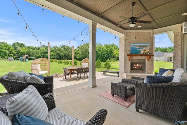 313 Merrydale Dr, Huntsville, AL 35811 - view of patio / terrace with an outdoor living space with a fireplace, ceiling fan, a playground, and outdoor dining area