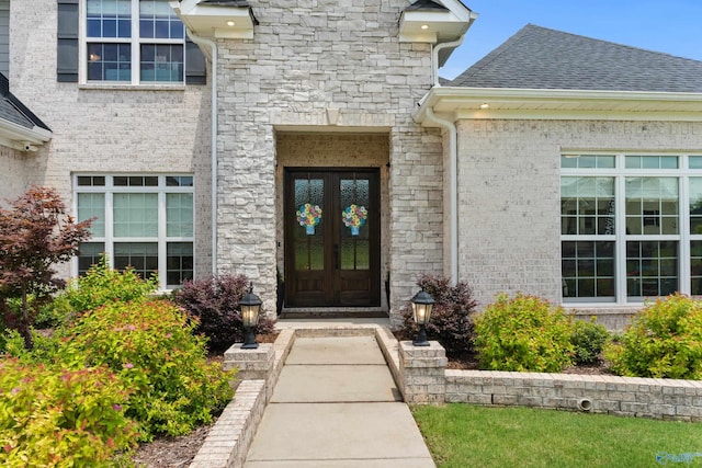313 Merrydale Dr, Huntsville, AL 35811 - view of exterior entry with stone siding, french doors, and roof with shingles