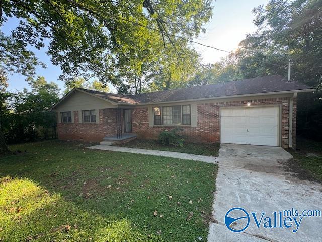 ranch-style home featuring a garage, brick siding, driveway, and a front yard