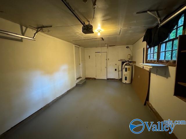 garage with water heater and a garage door opener