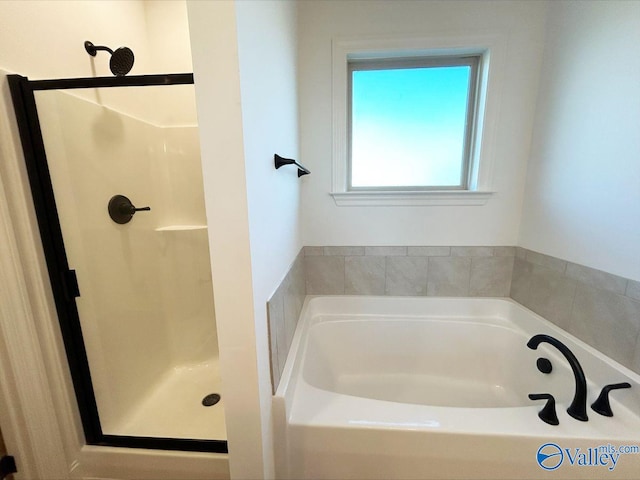 full bath featuring a bath and a shower stall