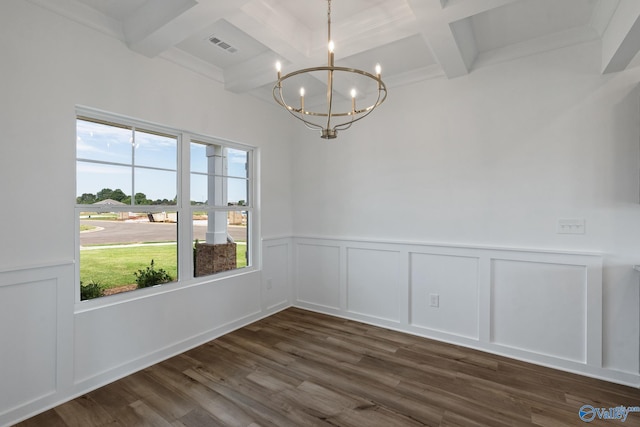 interior space with dark hardwood / wood-style flooring, a chandelier, beam ceiling, coffered ceiling, and crown molding