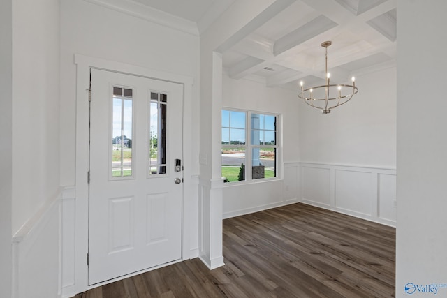 foyer entrance with coffered ceiling, dark hardwood / wood-style flooring, beamed ceiling, crown molding, and a chandelier