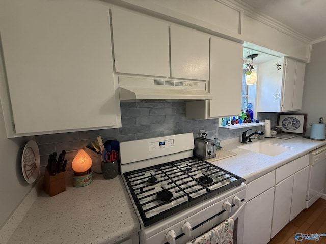 1128 Brashiers Chapel Rd, Arab, AL 35016 - kitchen featuring white appliances, under cabinet range hood, crown molding, light countertops, and decorative backsplash