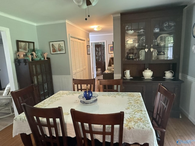1128 Brashiers Chapel Rd, Arab, AL 35016 - dining space featuring wood finished floors, wainscoting, ornamental molding, and ceiling fan