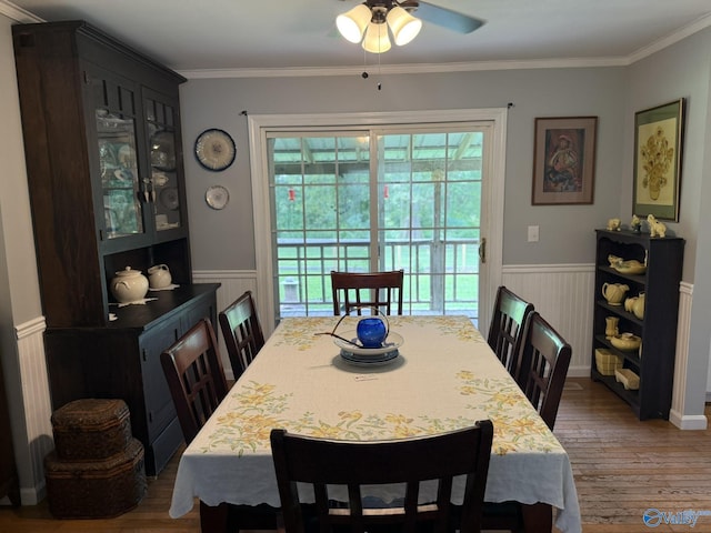 1128 Brashiers Chapel Rd, Arab, AL 35016 - dining area featuring wainscoting, wood finished floors, ceiling fan, and ornamental molding