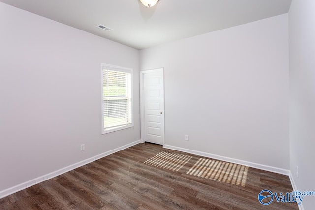 empty room with dark wood-type flooring