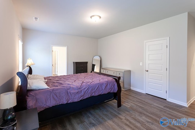 bedroom with dark hardwood / wood-style floors