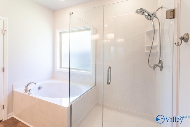 bathroom featuring separate shower and tub