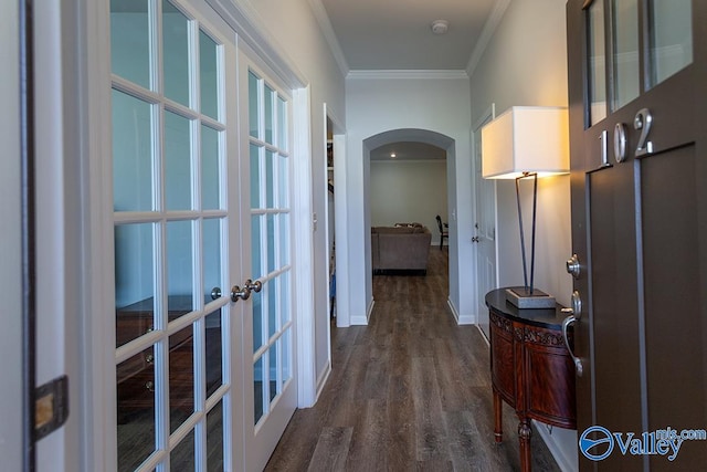 hall featuring dark wood-type flooring, crown molding, and french doors