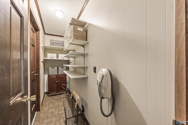 bathroom featuring a textured ceiling and crown molding