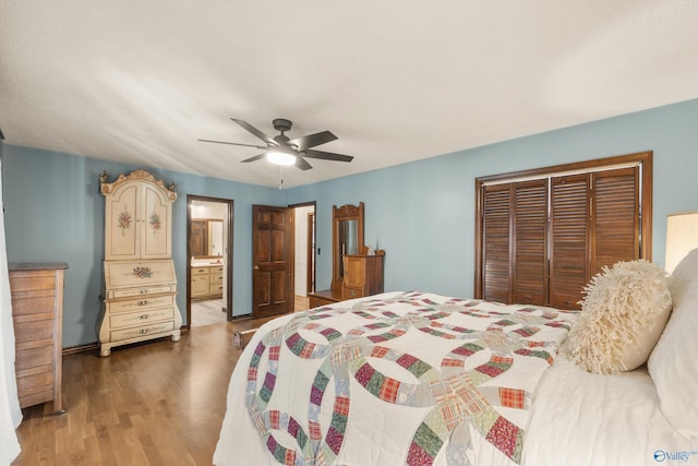 bedroom featuring a closet, ensuite bath, ceiling fan, and hardwood / wood-style flooring