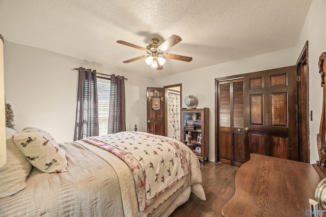 bedroom with ceiling fan, dark hardwood / wood-style flooring, and a textured ceiling