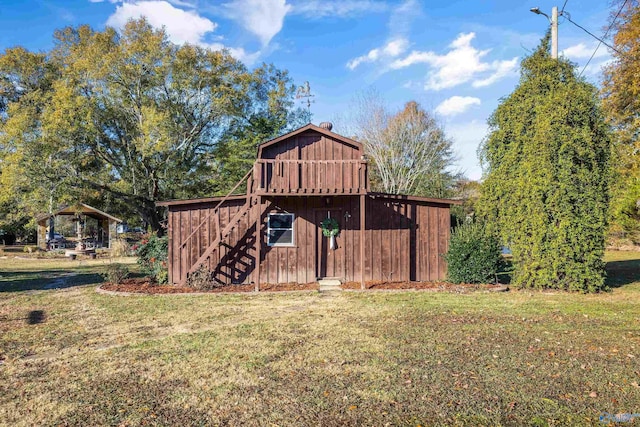 view of outbuilding featuring a lawn