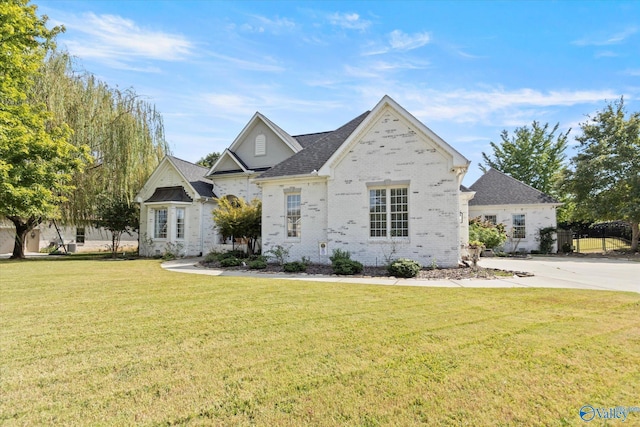 4716 Slalom Run SE, Owens Cross Roads, AL 35763 - view of front of house featuring brick siding, a front lawn, and roof with shingles