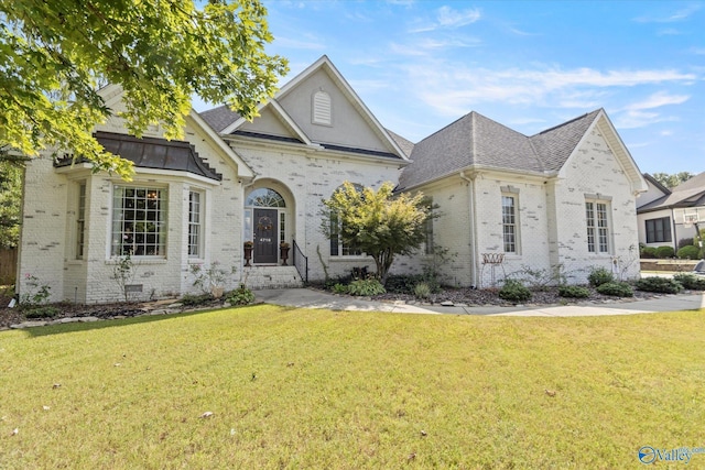 4716 Slalom Run SE, Owens Cross Roads, AL 35763 - french country inspired facade with brick siding, a shingled roof, and a front lawn
