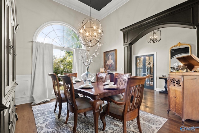 4716 Slalom Run SE, Owens Cross Roads, AL 35763 - dining area featuring an inviting chandelier, ornamental molding, dark wood-style flooring, and a towering ceiling
