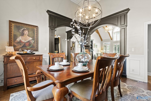 4716 Slalom Run SE, Owens Cross Roads, AL 35763 - dining space featuring arched walkways, a notable chandelier, wood finished floors, and visible vents