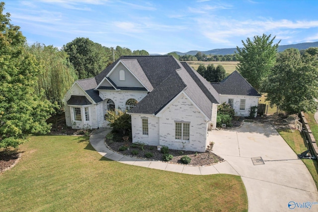 4716 Slalom Run SE, Owens Cross Roads, AL 35763 - view of front of property featuring a front lawn, stone siding, roof with shingles, brick siding, and driveway
