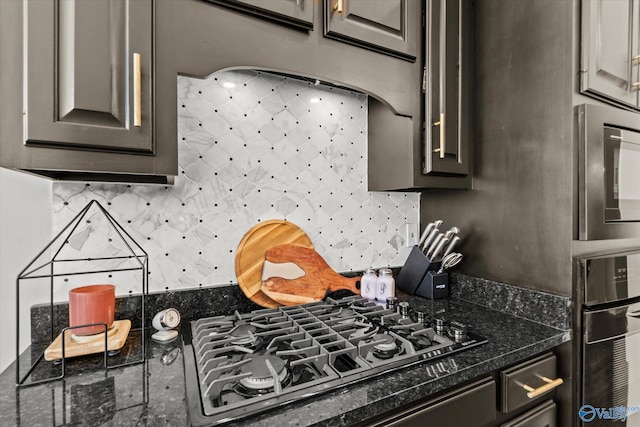 kitchen with backsplash, wall oven, black gas cooktop, dark stone counters, and dark brown cabinetry