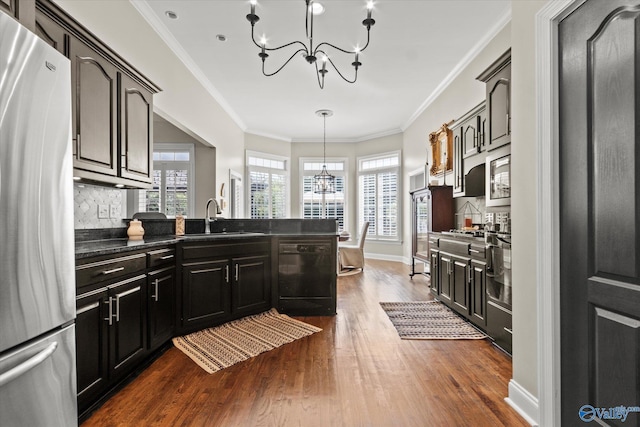 4716 Slalom Run SE, Owens Cross Roads, AL 35763 - kitchen featuring appliances with stainless steel finishes, dark countertops, dark wood finished floors, a sink, and a notable chandelier