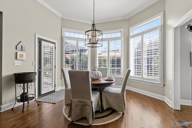 dining room featuring crown molding, a notable chandelier, and dark hardwood / wood-style floors