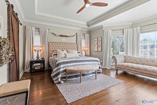 4716 Slalom Run SE, Owens Cross Roads, AL 35763 - bedroom featuring a raised ceiling, a ceiling fan, a barn door, and dark wood-type flooring