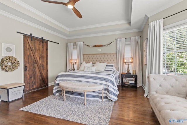 4716 Slalom Run SE, Owens Cross Roads, AL 35763 - bedroom with crown molding, wood finished floors, ceiling fan, a barn door, and a tray ceiling