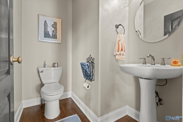 4716 Slalom Run SE, Owens Cross Roads, AL 35763 - bathroom with baseboards, a sink, wood finished floors, and toilet